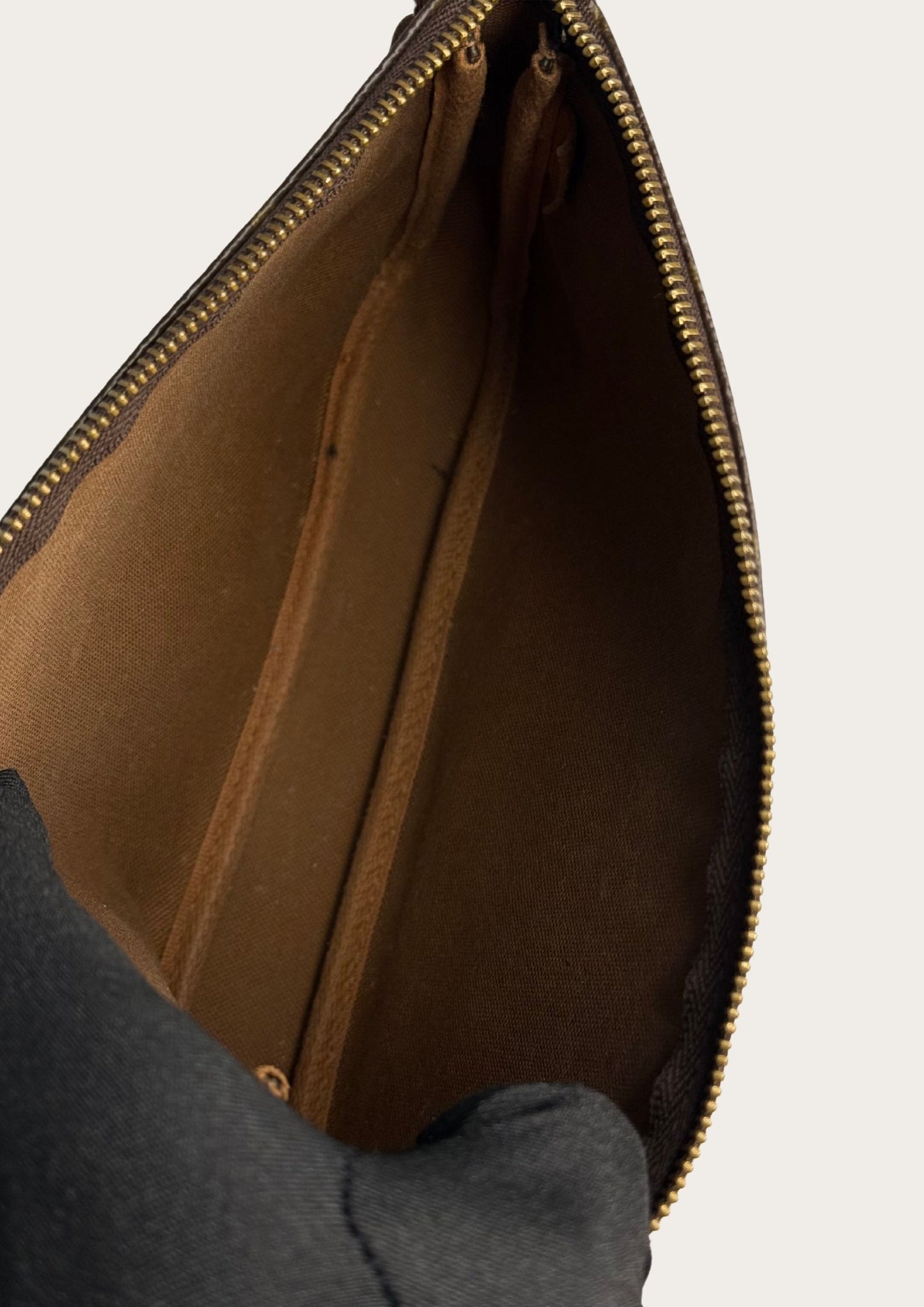 Inside Classic and authentic Louis Vuitton Pochette accessory bag in monogram leather