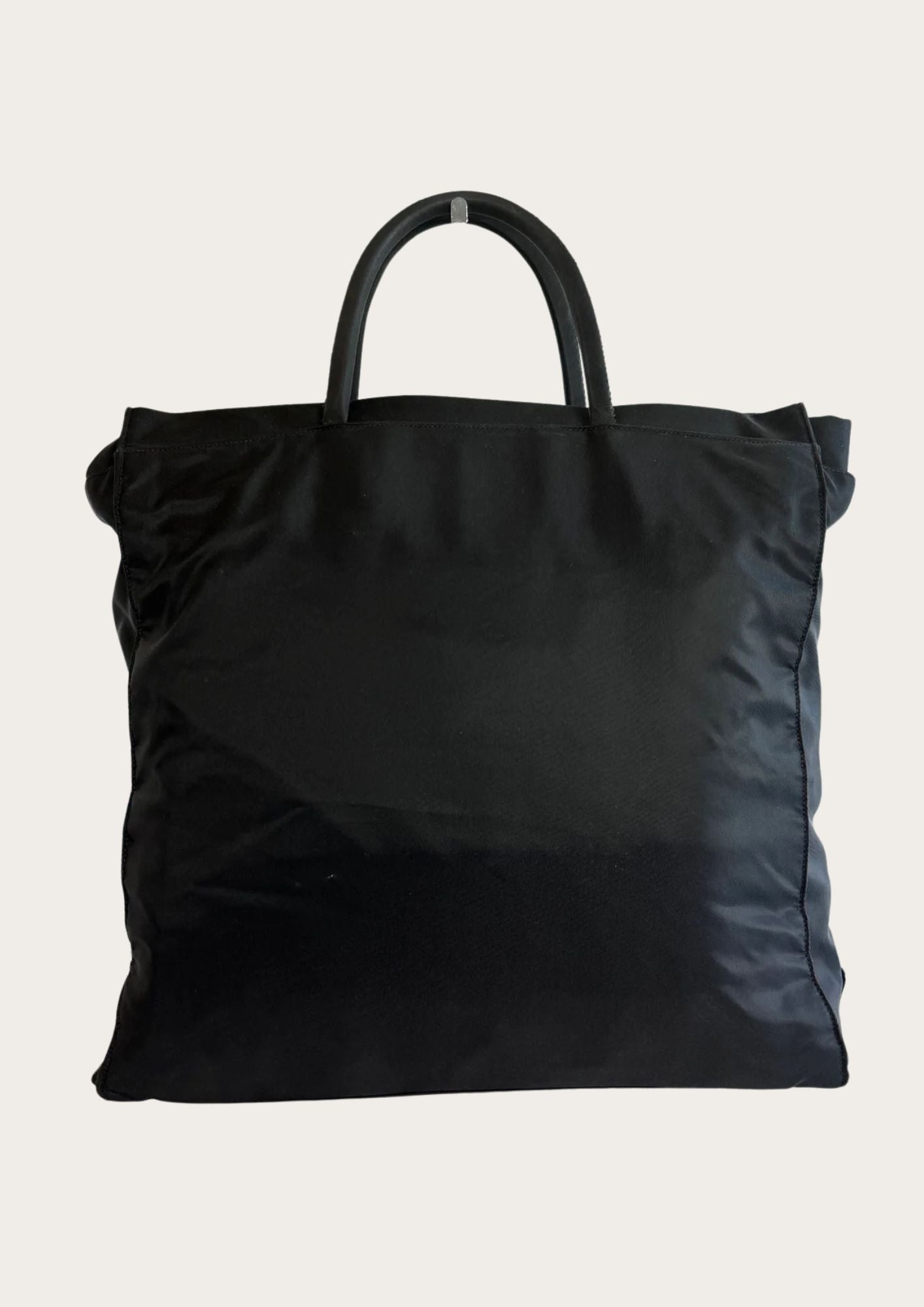 Backside of authentic Prada nylon tote bag in black.