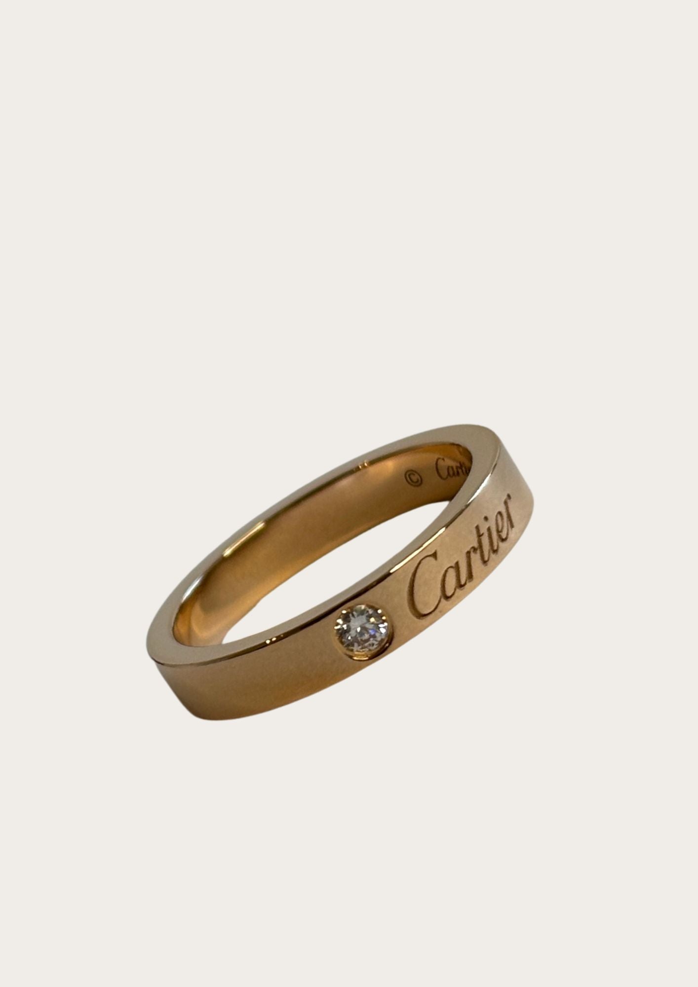 Pre-owned authentic Cartier C de Cartier ring with one diamond and Cartier brand