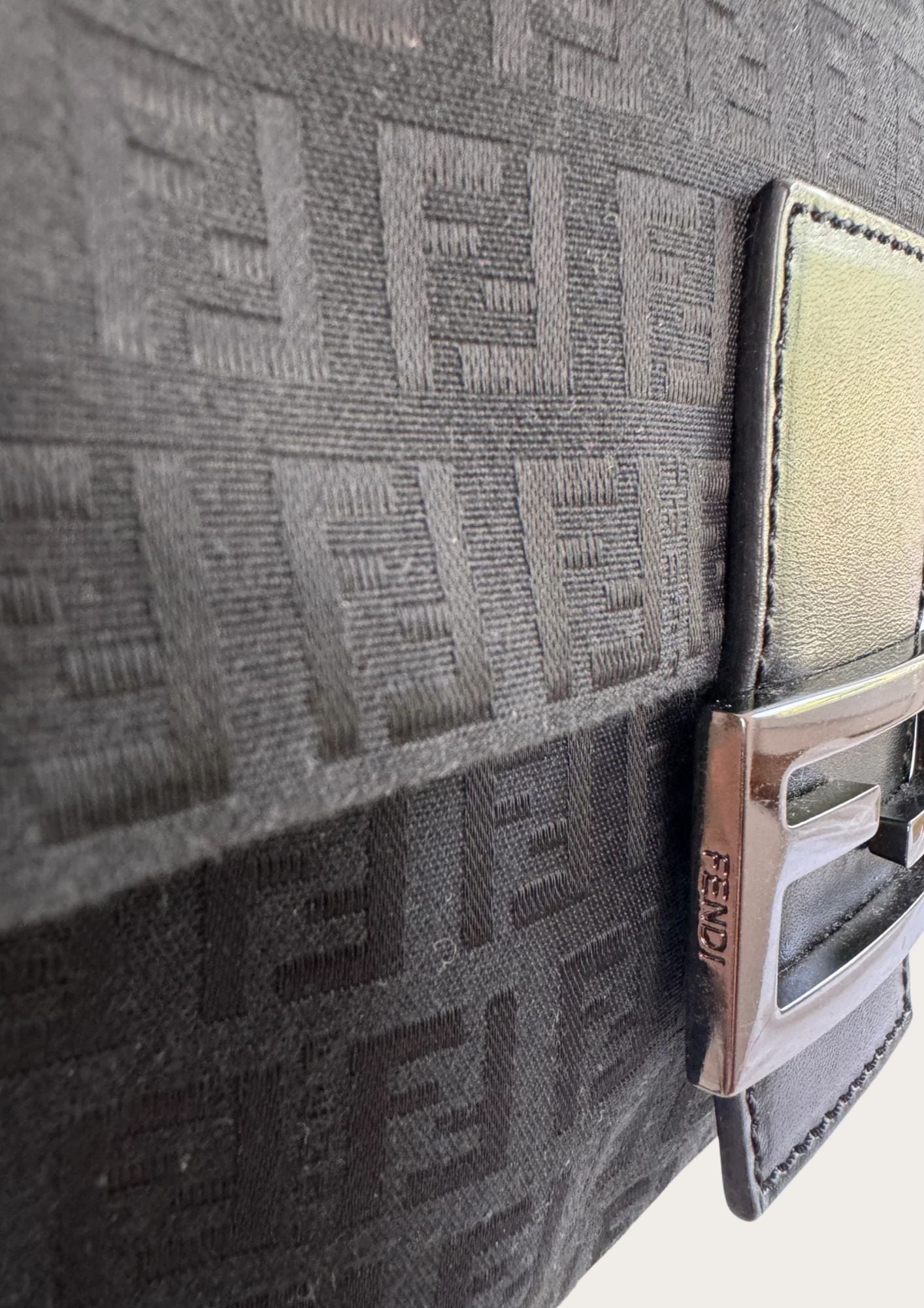 Detail photo of Fendi logo on Zucchino shoulder bag.