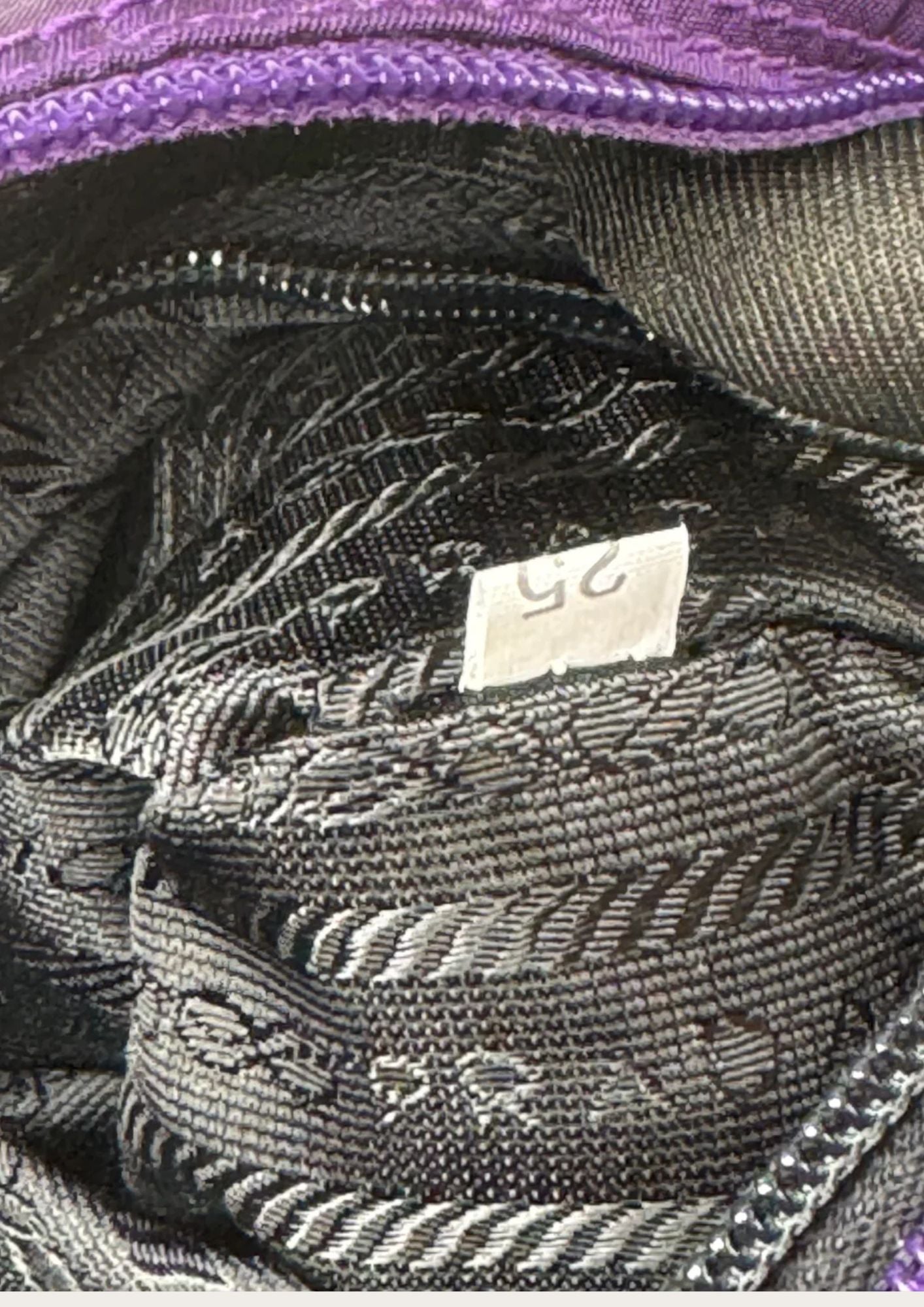 Authentic Prada Tessuto Metallo bag in purple nylon with golden hardware, authenticity code.