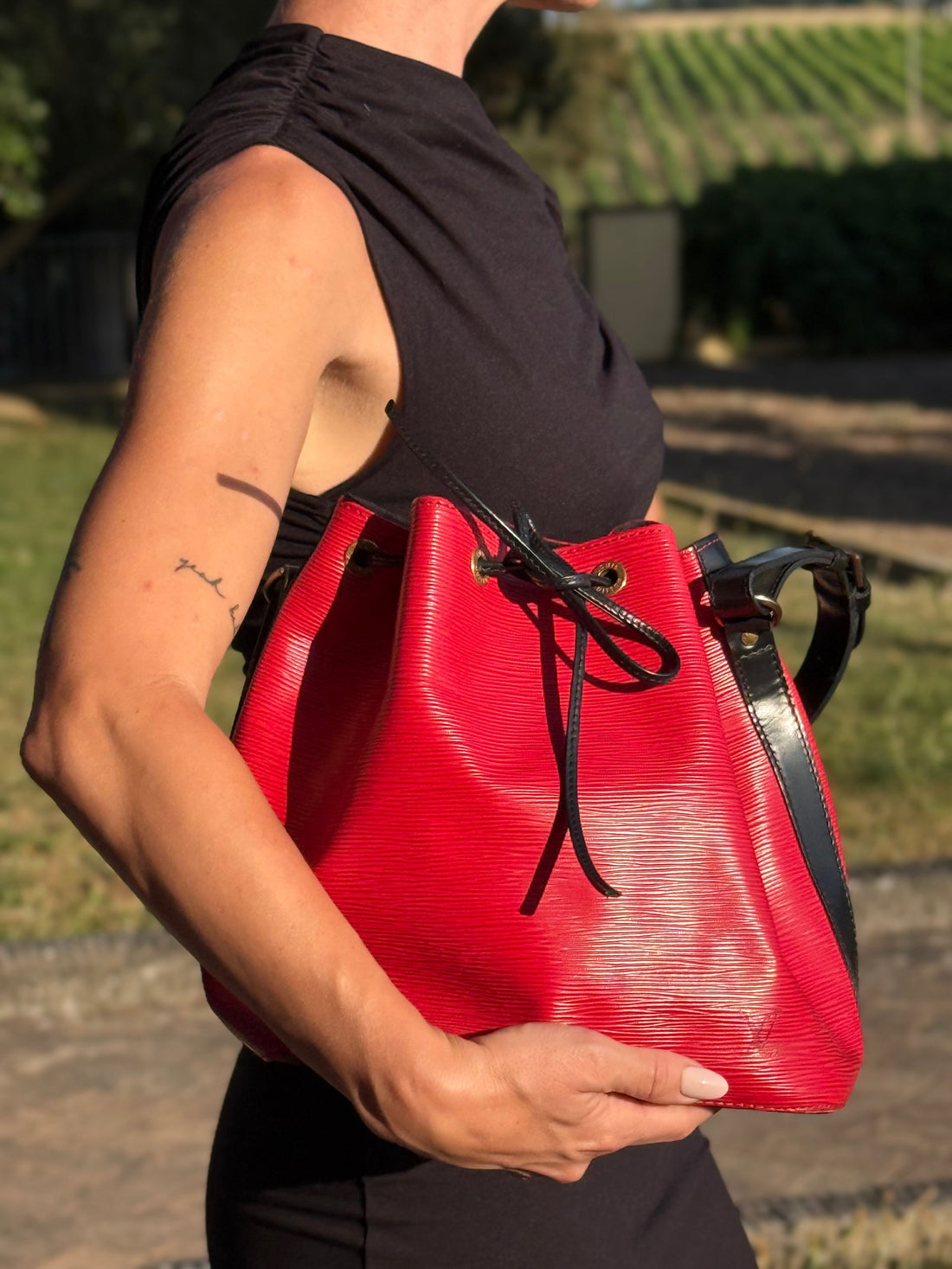 Louis Vuitton Petit Noé in red epi leather with black details