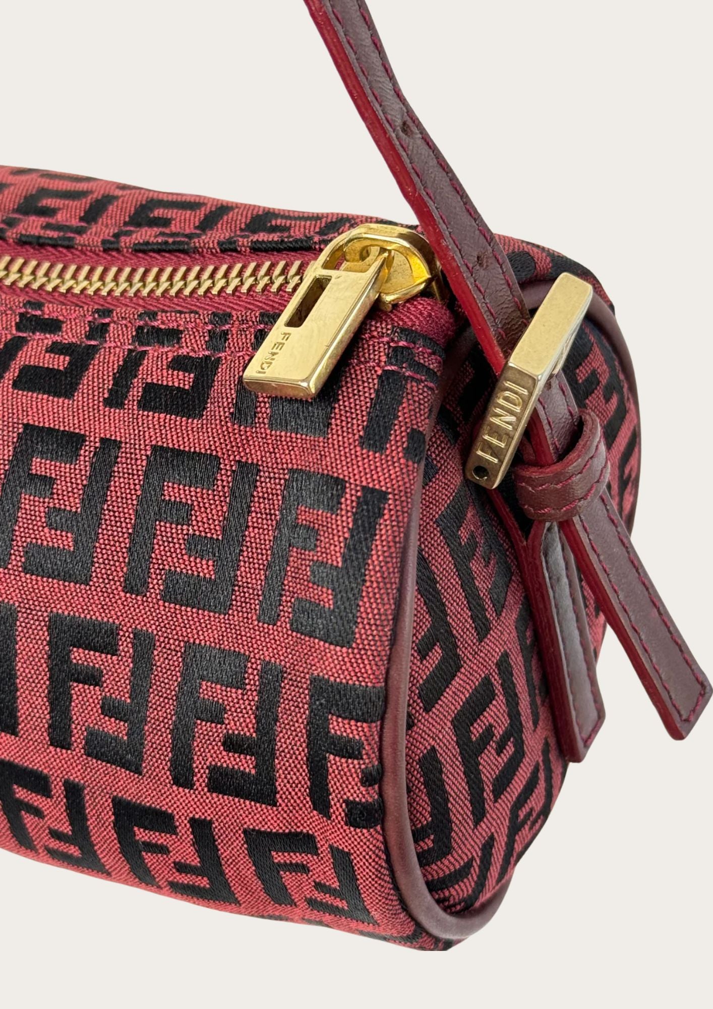 100% authentic Fendi Zucchino barrel bag in burgundy red, detail photo.